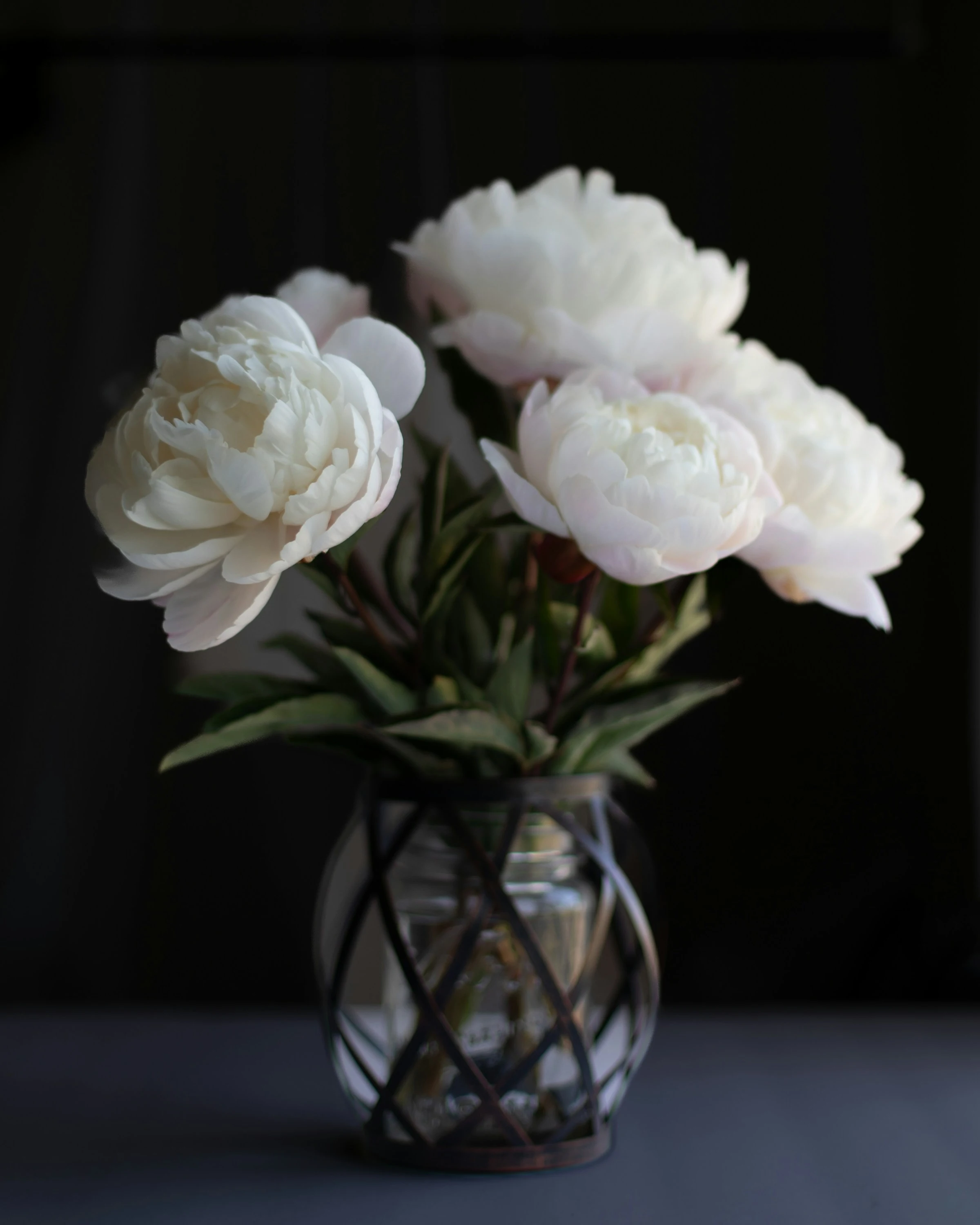 Peony centerpiece with blush and ivory blooms on a reception table